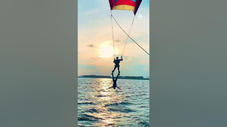 Woman Hangs Upside Down From Parasailer | People Are Awesome