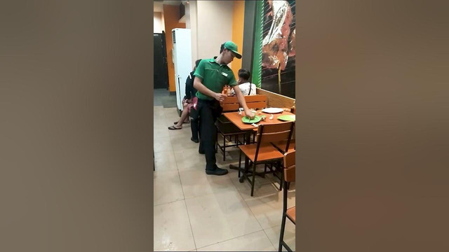 Waiter Efficiently Cleans and Sets Table