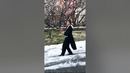Guy Slides Down Icy Road While Wearing Suit and Holding Wine Glass in his Hand