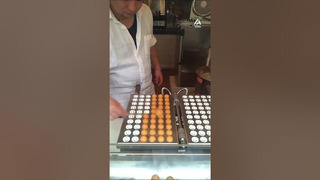 Chef Flicks Fresh Pastries off Pan