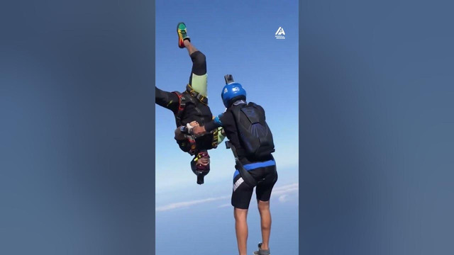 Two Men Perform Spinning Trick While Skydiving