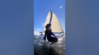 Woman in Witch Costume Flies Over Water While Hanging on Harness Swing on Sailboat