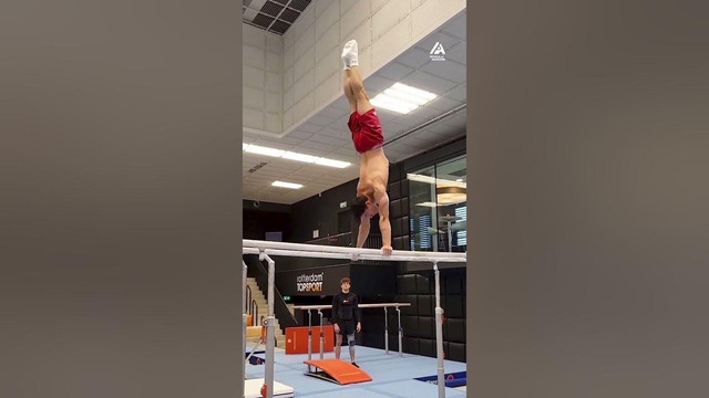 Guy Performs Gymnastics on Parallel Bars