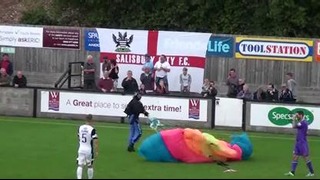 Parachutist lands on pitch during game – YouTube