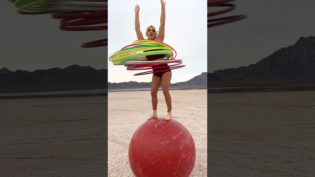 Most hula hoops spun simultaneously while balancing on a giant rolling globe – 28 by Grace Good