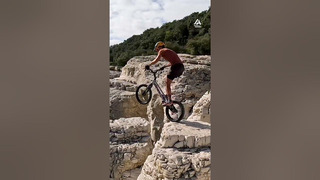 Man Practices BMX Skills on Rock Formations