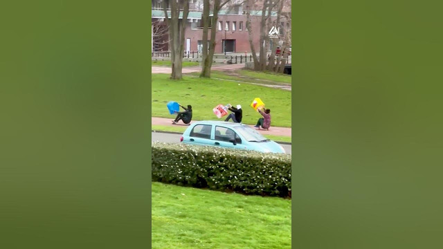 Trio Skateboards During Storm Using Plastic Bags To Propel Their Rides