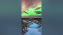 A geomagnetic storm illuminates Iceland’s stunning Brúarfoss waterfall with green and red hues