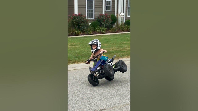 Kid Drives Quad Bike While Balancing on Two Wheels