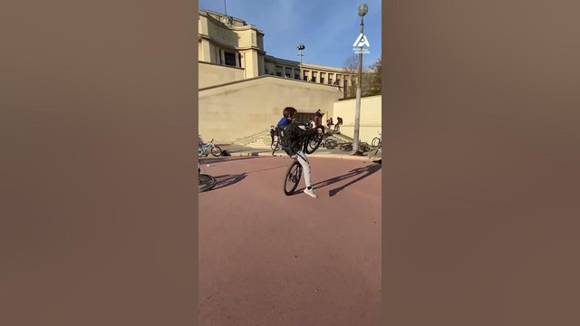 Boy does Astounding Wheelies on His Bike in Front of Eiffel Tower