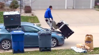 Man Loads an Old Grill onto the Roof of His Car