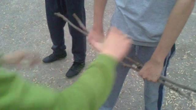 Парень разбивает ветку рукой