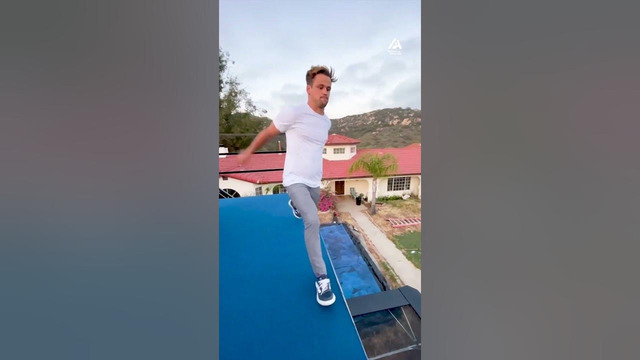 Guy Performs Flips While Jumping Off Platform on Trampoline And Does Handstand
