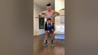 Man Does Bicep Curls With Kid