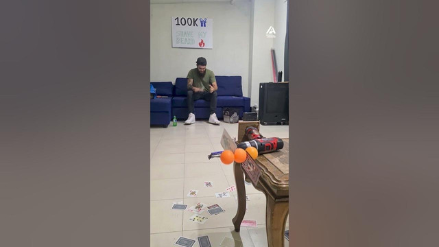 Man Throws Cards at Rotating Targets