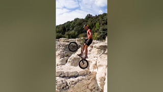 Man Practices BMX Skills on Rock Formations
