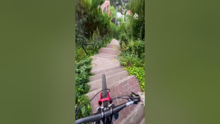 Mountain Biker Conquers Treacherous Downhill Trail with Skill