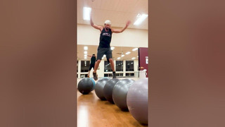 Man Displays Exemplary Balance By Hopping From One Yoga Ball to Another