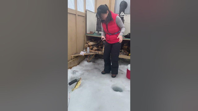 Woman Catches Her First Perch While Ice Fishing